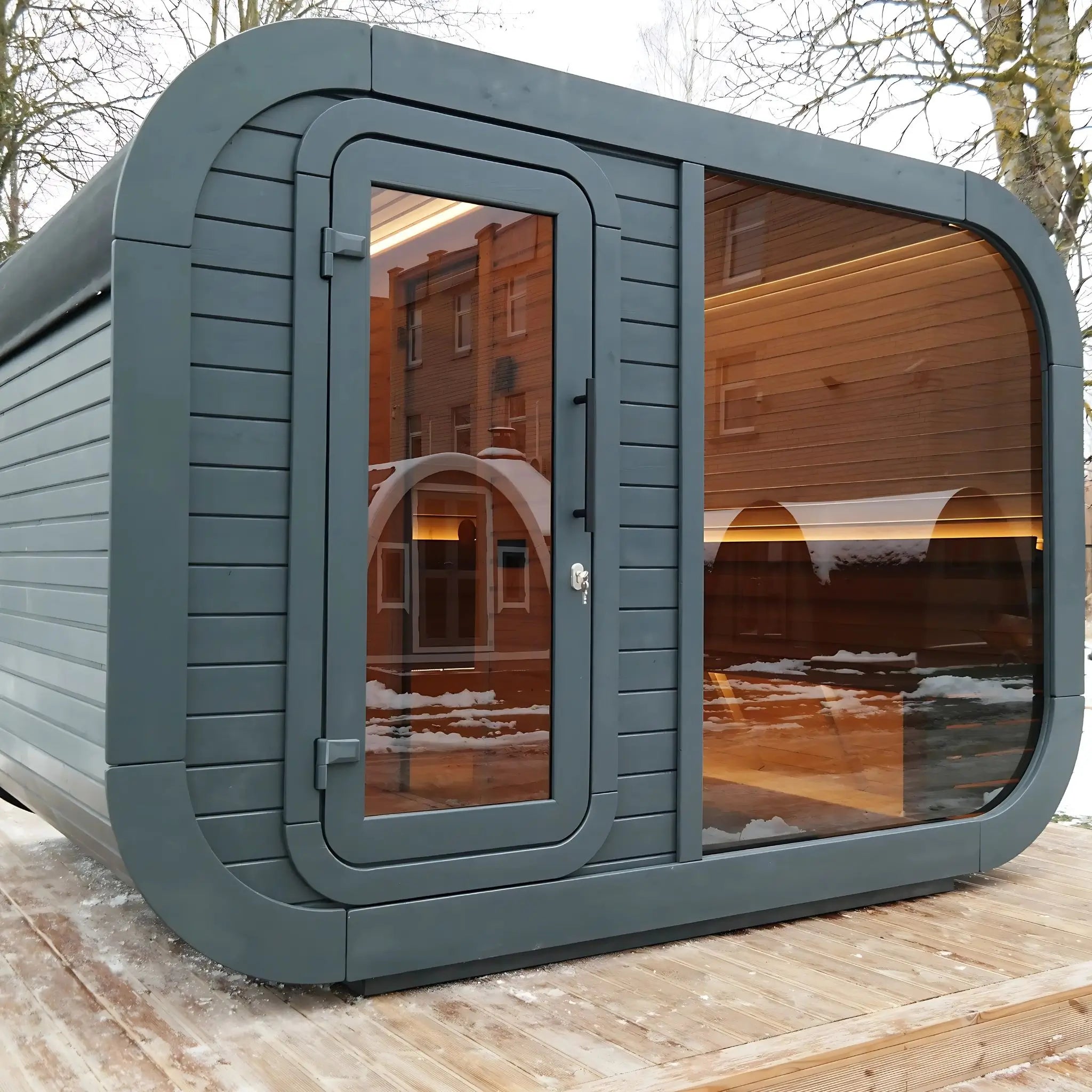 Stylish black wood sauna cabin by GlampLaunch featuring a glass door and traditional design with built-in changing room for outdoor wellness retreats