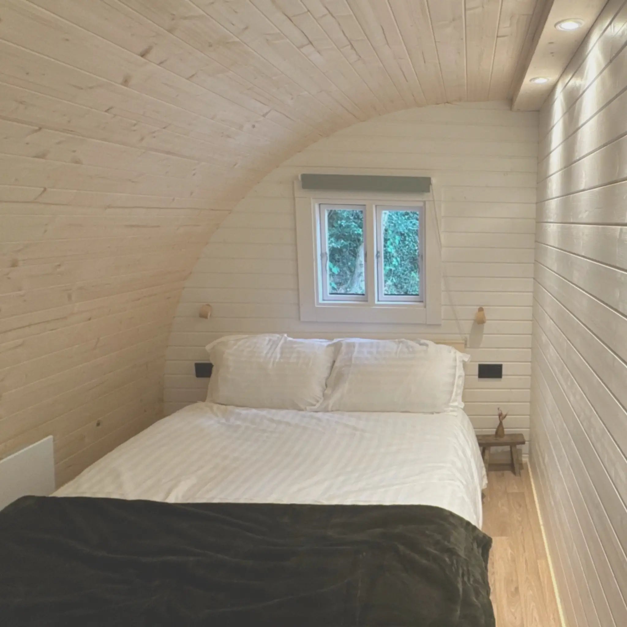 Glamping pod bedroom interior featuring hospitality grade mattress for long term guest comfort