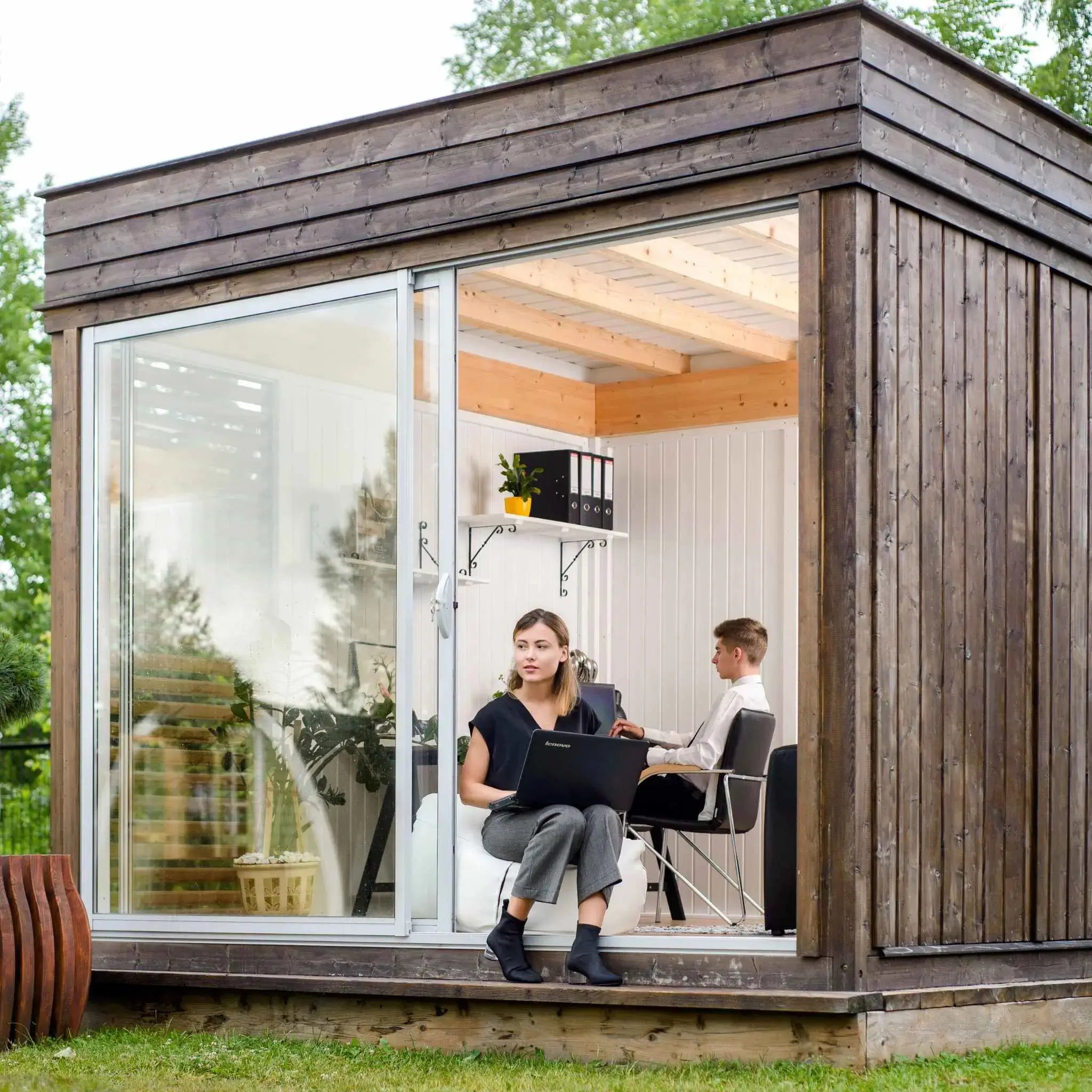 Exterior front view of a small modular garden office cube with glass doors, 2025 modern workspace solution.