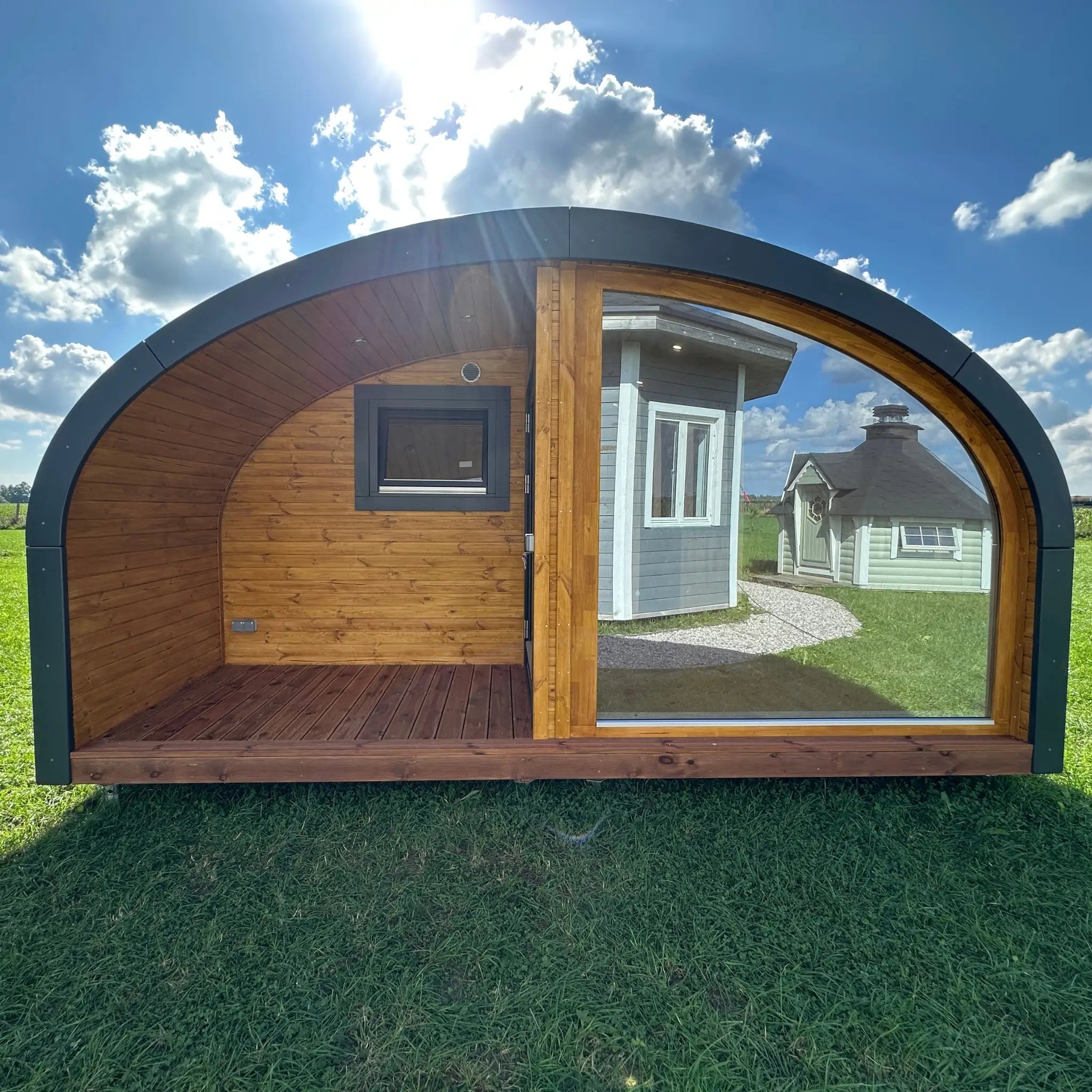 Exterior and interior views of the XL Dual Halfmoon glamping pod by GlampLaunch, a 4-person timber pod featuring a large panoramic window, natural wood interior, and open countryside views.