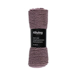 Mauve 4Living chenille bathroom mat rolled with product label on a white background.