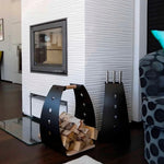 Black and white fireplace tool kits styled beside a white textured fireplace with a black log carrier filled with firewood.
