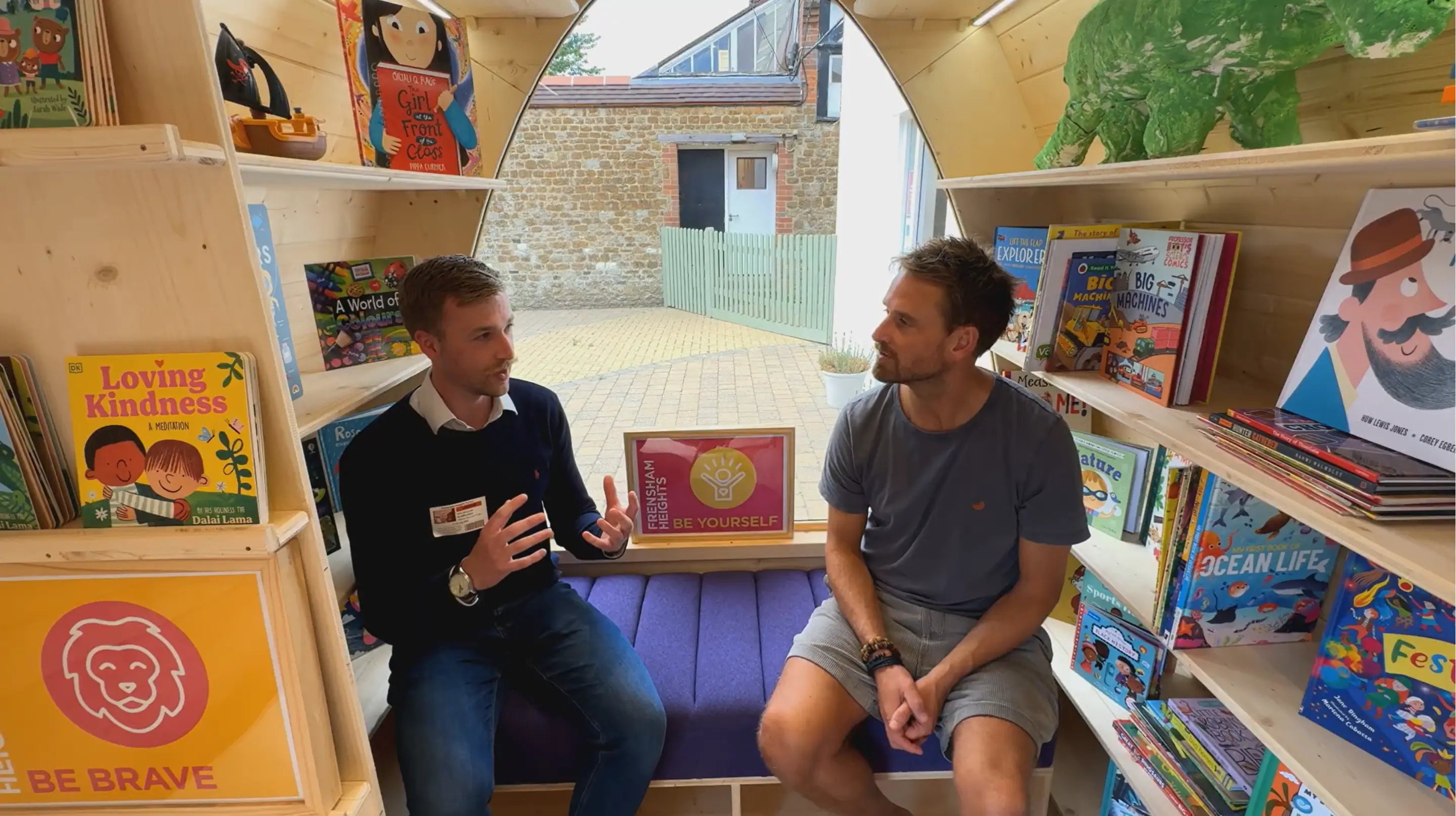 Taylor Glass, founder of GlampLaunch, interviewing Nick at Frensham Heights inside a bespoke library pod – showing the founder-led, personal approach to pod projects.