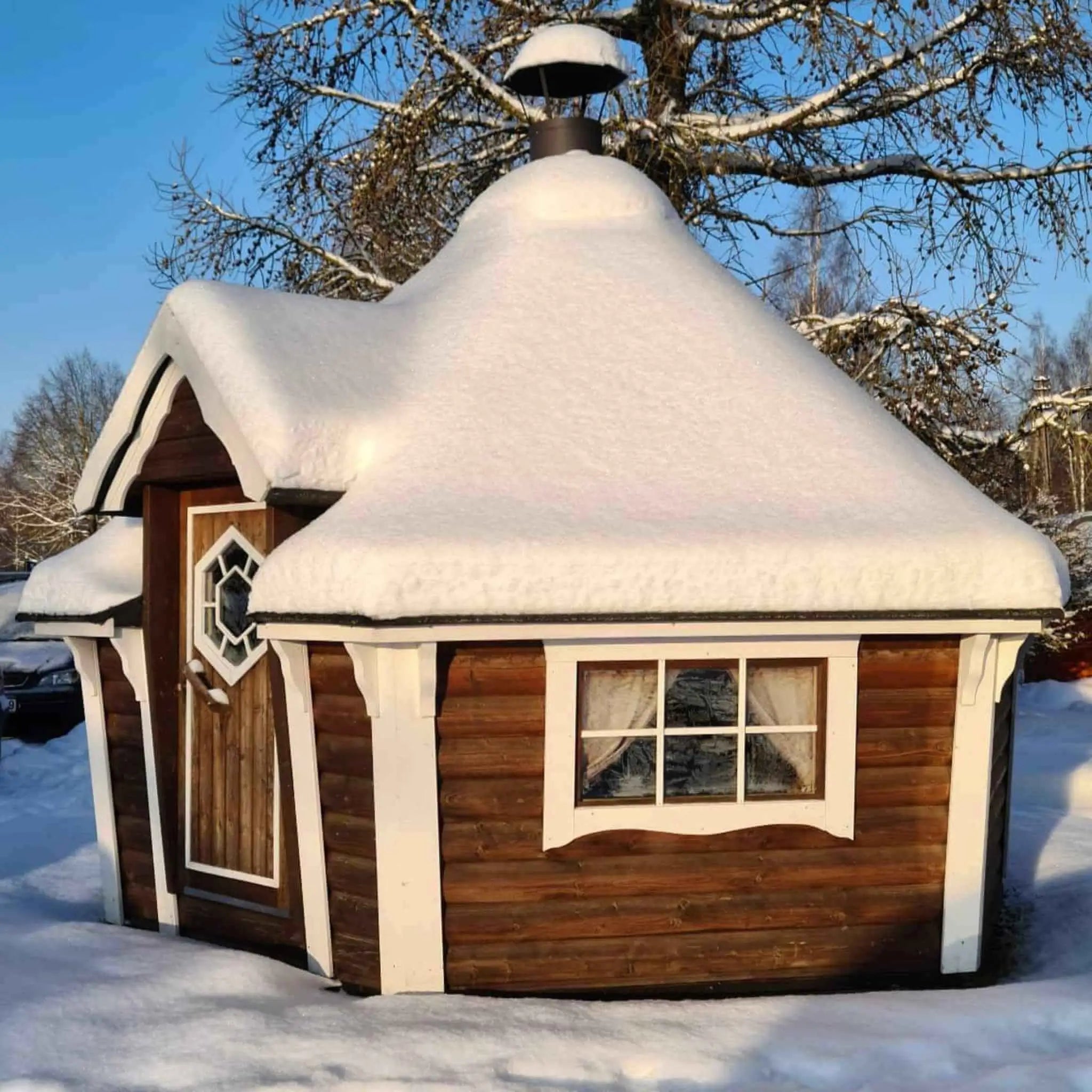 Brown Glamping Cabin with Snow on Roof