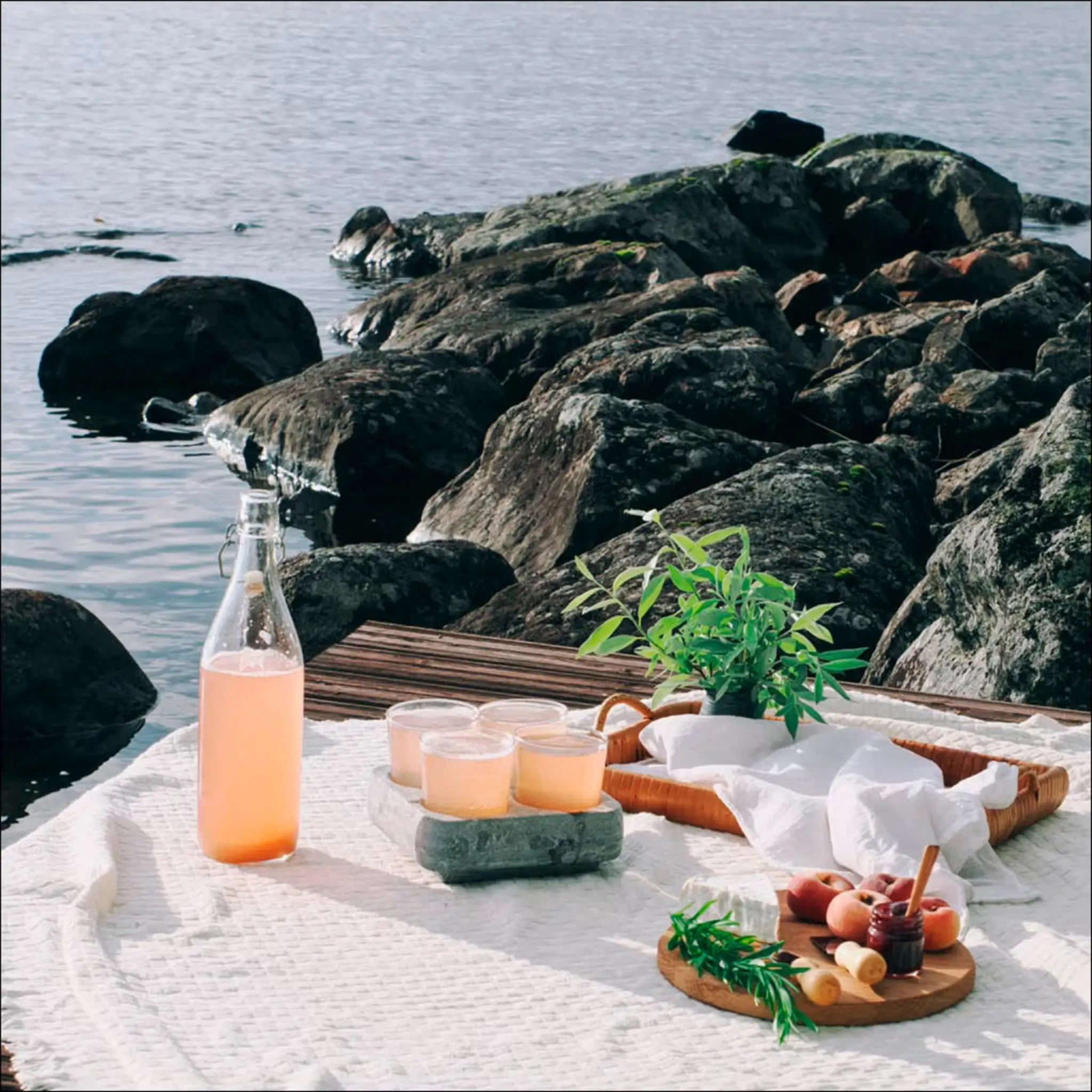 Hukka Huurteinen soapstone drink cooler used outdoors with drinks by the water
