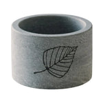 Hukka Saunaviilee soapstone drink cooler with leaf engraving on a white background.