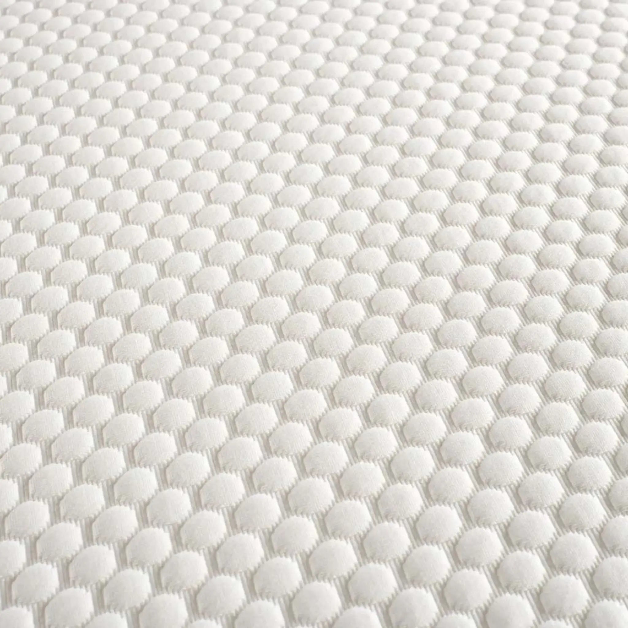 Close-up of the Komfi Unity Pocket Mattress breathable textured fabric cover designed for long-lasting commercial performance.