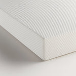 Corner detail of the Komfi Unity Pocket Mattress showing durable textured fabric and commercial-grade construction.
