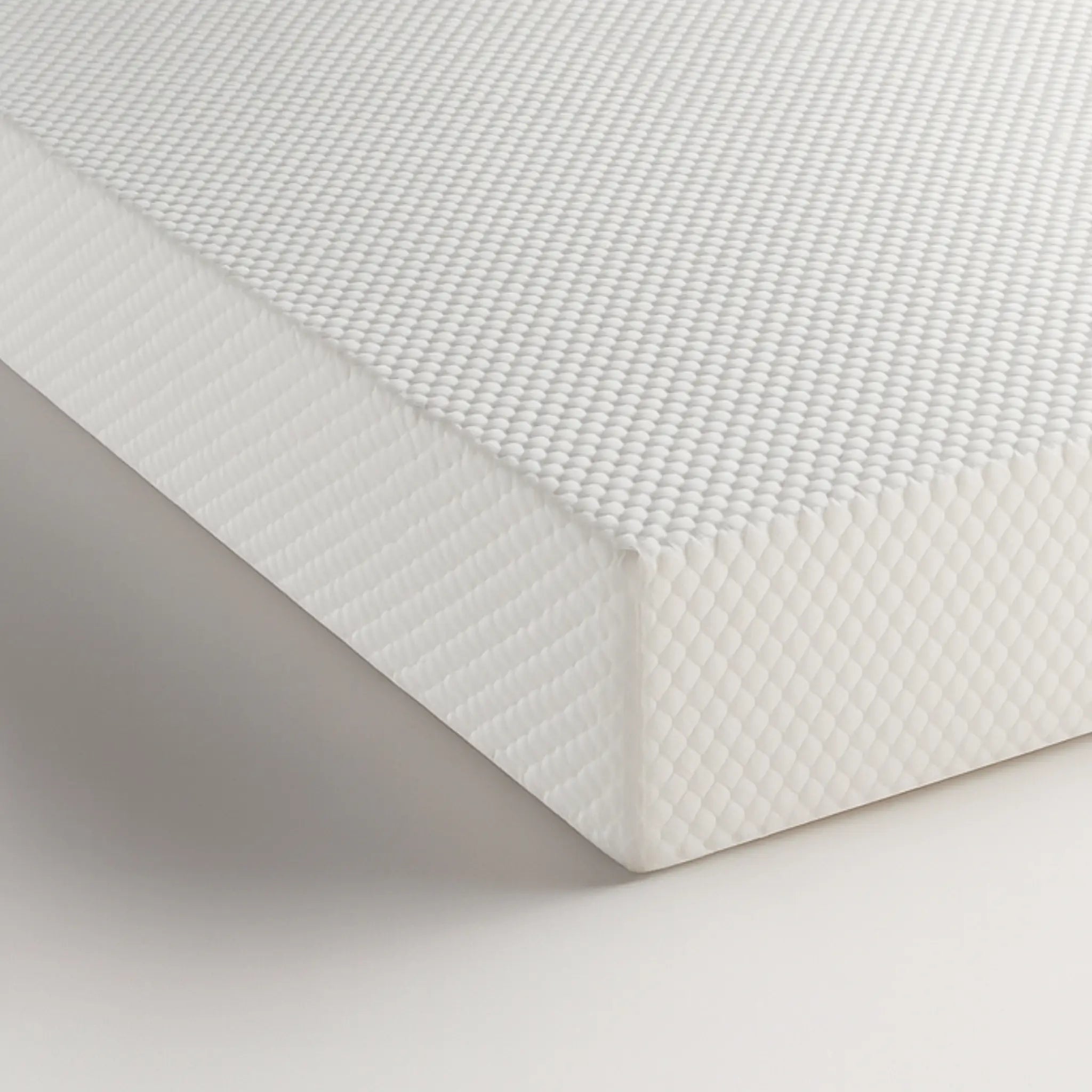 Corner detail of the Komfi Unity Pocket Mattress showing durable textured fabric and commercial-grade construction.