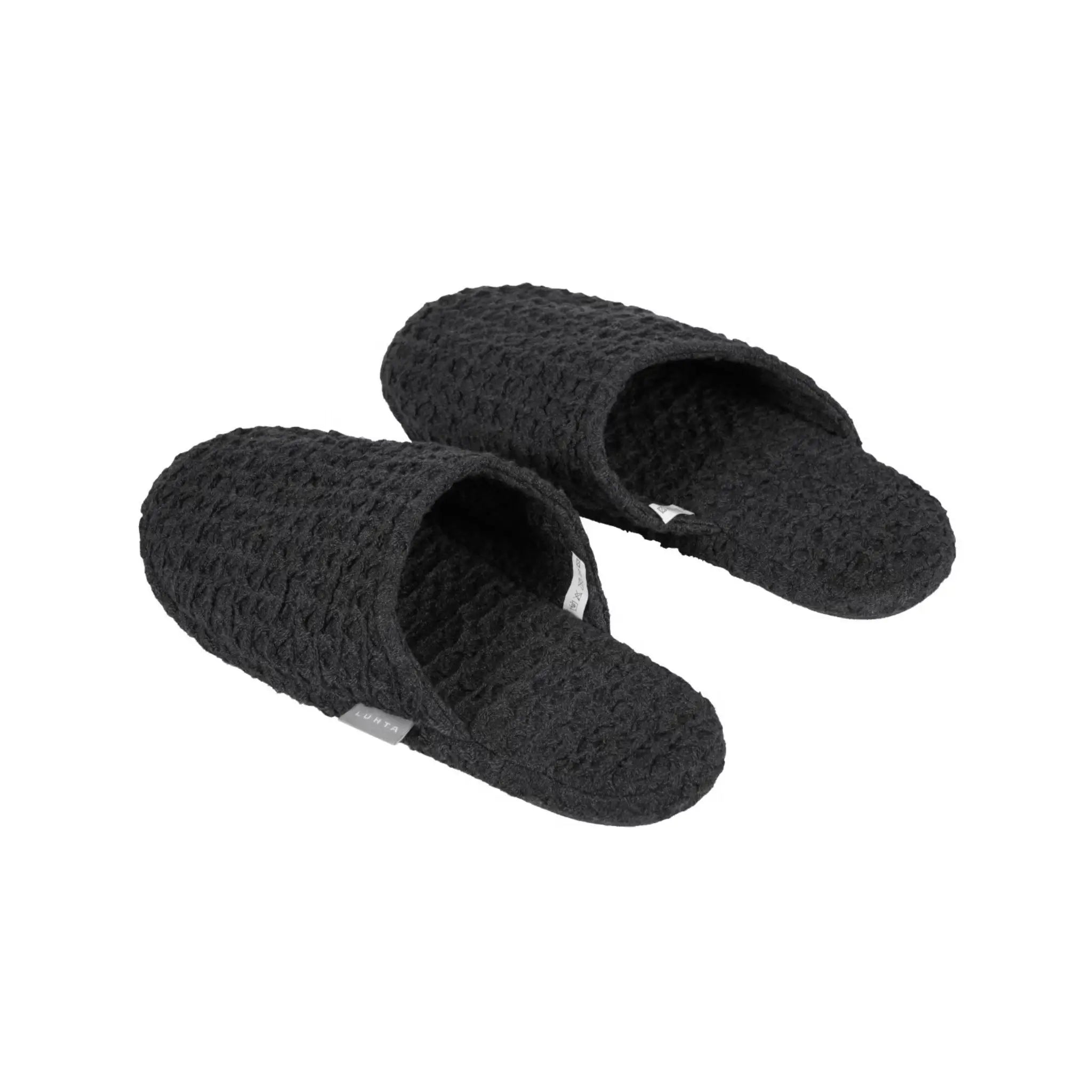 Black Luhta Home Pellava slippers with textured waffle fabric on a white background.