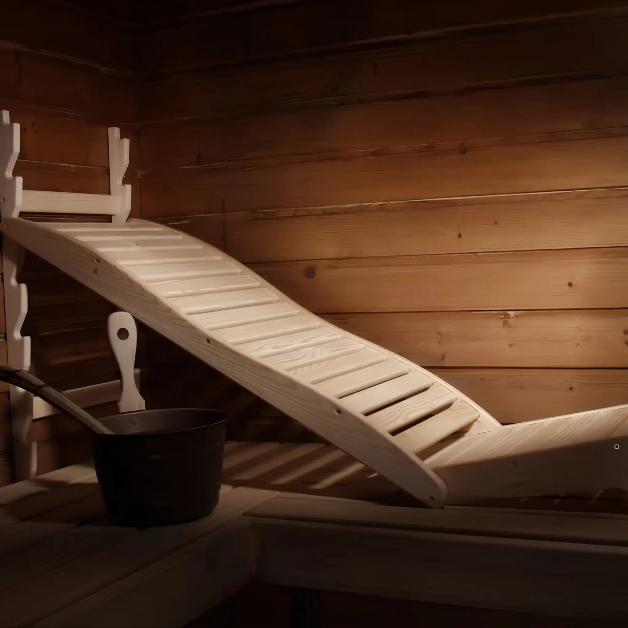 Pinetta Lepo adjustable pine sauna chair positioned on a wooden sauna bench with slatted reclined backrest design