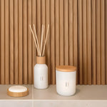 Scandinavian-style birch reed diffuser and candle creating a calming home atmosphere