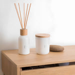 Rento Birch room fragrance diffuser and candle on wooden cabinet with decorative stone