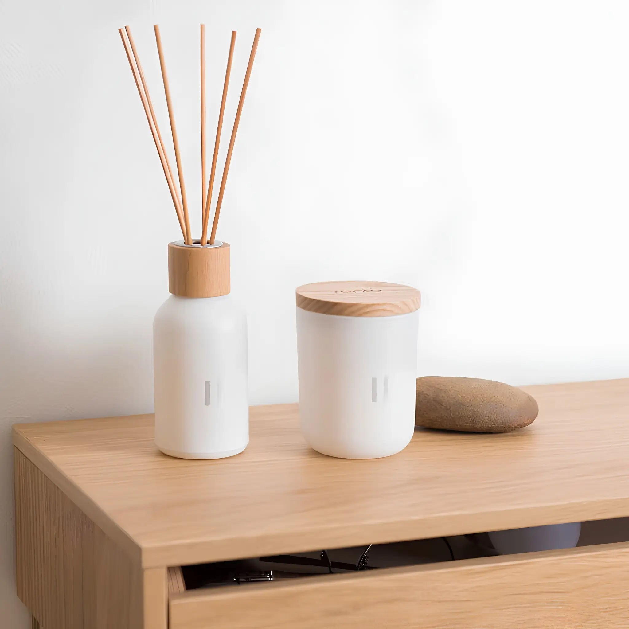 Rento Birch room fragrance diffuser and candle on wooden cabinet with decorative stone