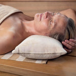 Close-up of beige Rento Kenno sauna pillow supporting the head during a relaxing sauna session