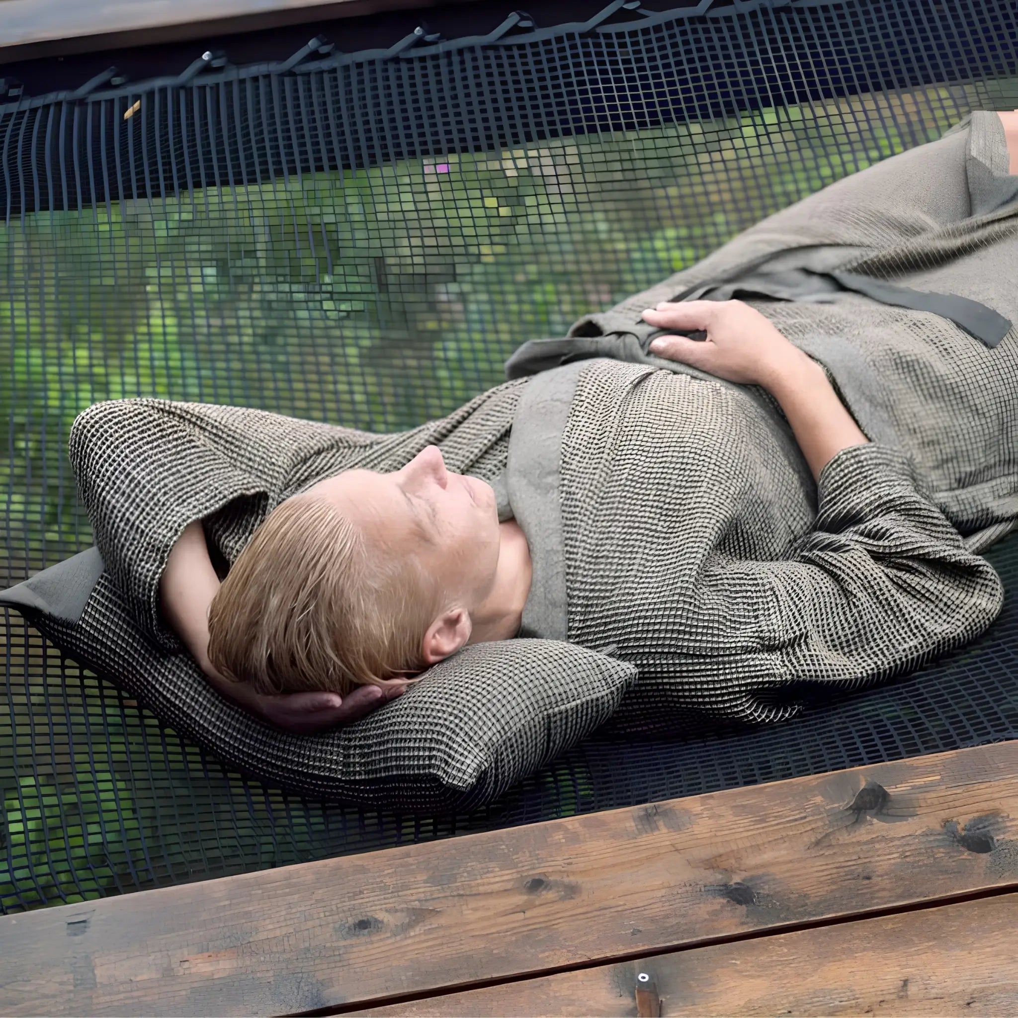 Brown Rento Kenno sauna pillow used as head support during an outdoor relaxation session
