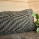 Brown Rento Kenno sauna pillow with matching seat cover and sauna accessories on a wooden bench