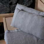 Grey white Rento Kenno sauna pillows and matching sauna seat cover inside a wooden sauna room