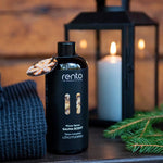 Rento Winter Spices Sauna Scent 400ml beside candle lantern and evergreen branches, creating a warm and cosy Finnish sauna atmosphere