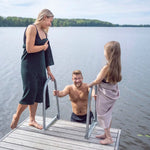 Family by a lake using dark green and pale pink waffle texture towels after swimming