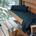 Dark green Rento Kenno sauna seat cover with matching pillows, sauna bucket and ladle
