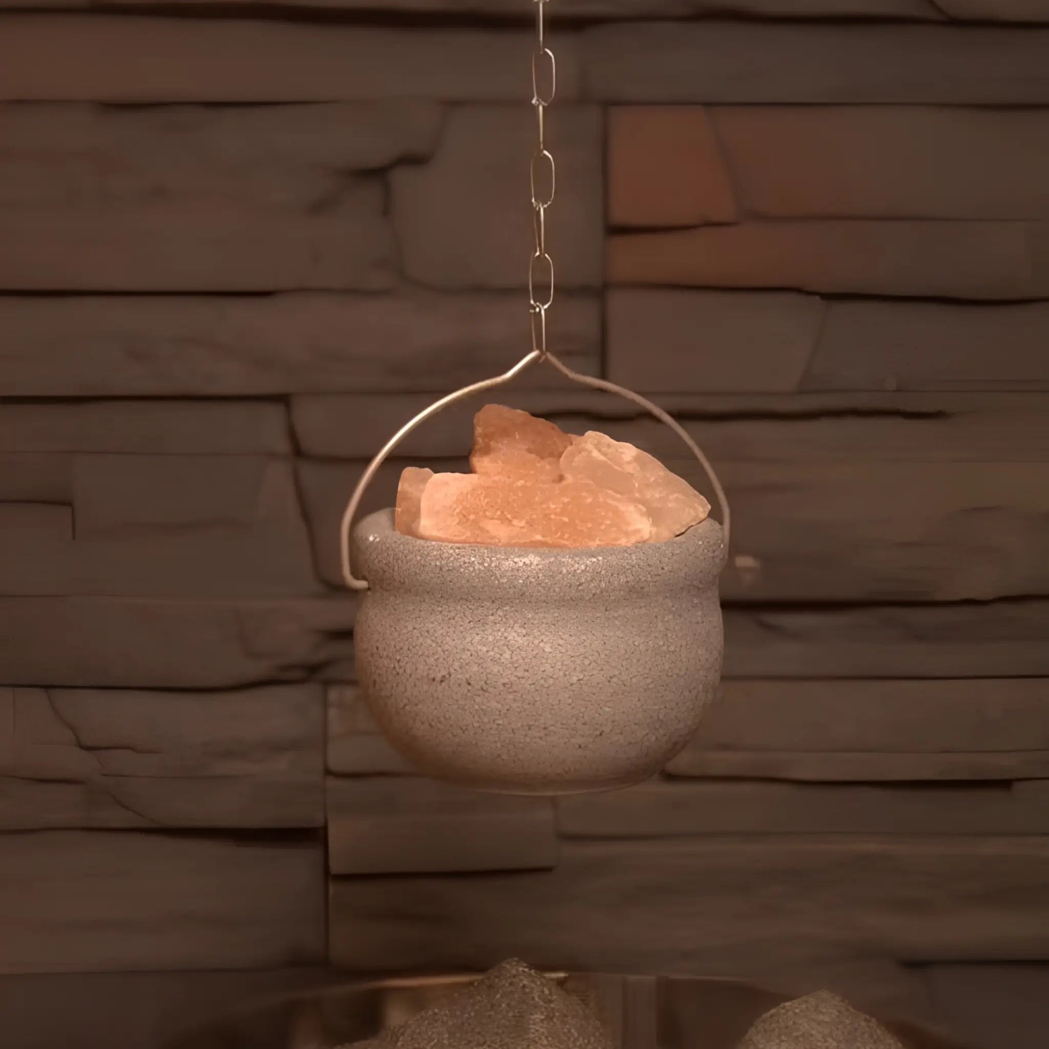 Saunia soapstone salt bowl hanging with Himalayan salt stones in a sauna