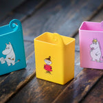 Colourful Mehujehu juice box holders with Moomin character designs on wooden surface