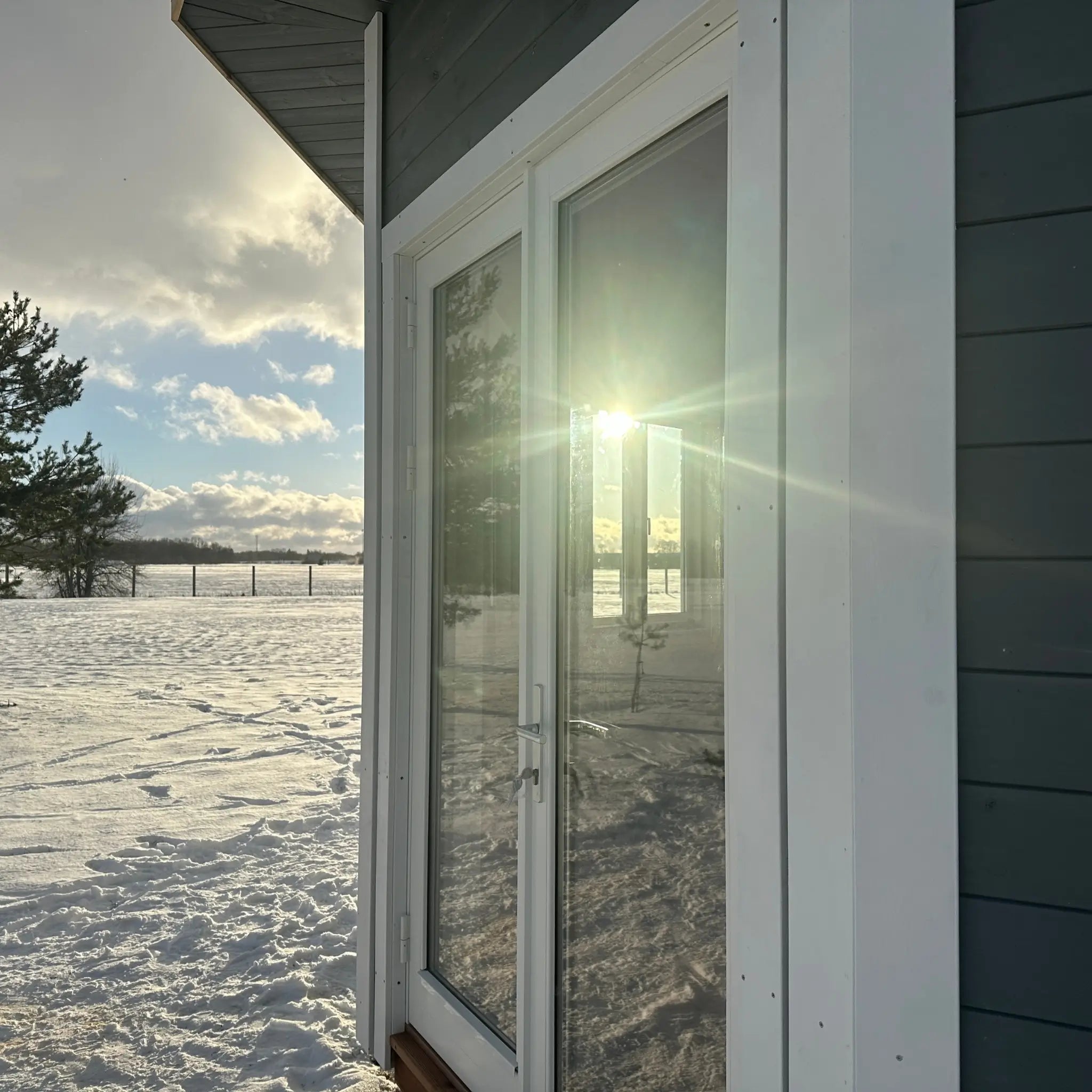 Close-up of the Altura Loft Cabin entrance with glazed double doors and white trim
