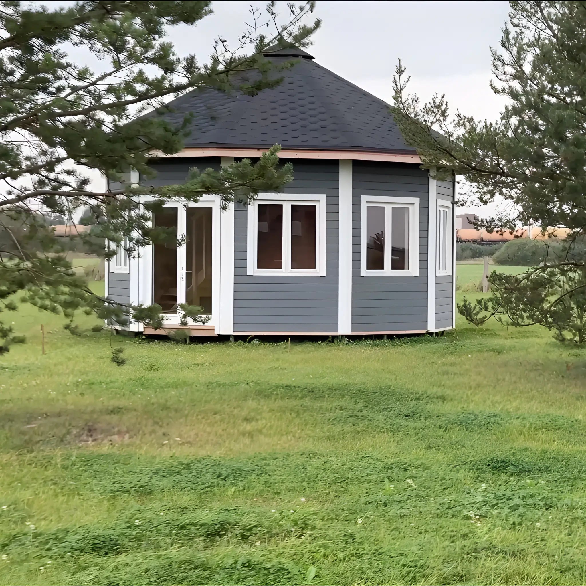 Full exterior view of the Altura Loft Cabin set in a natural landscape with pitched roof