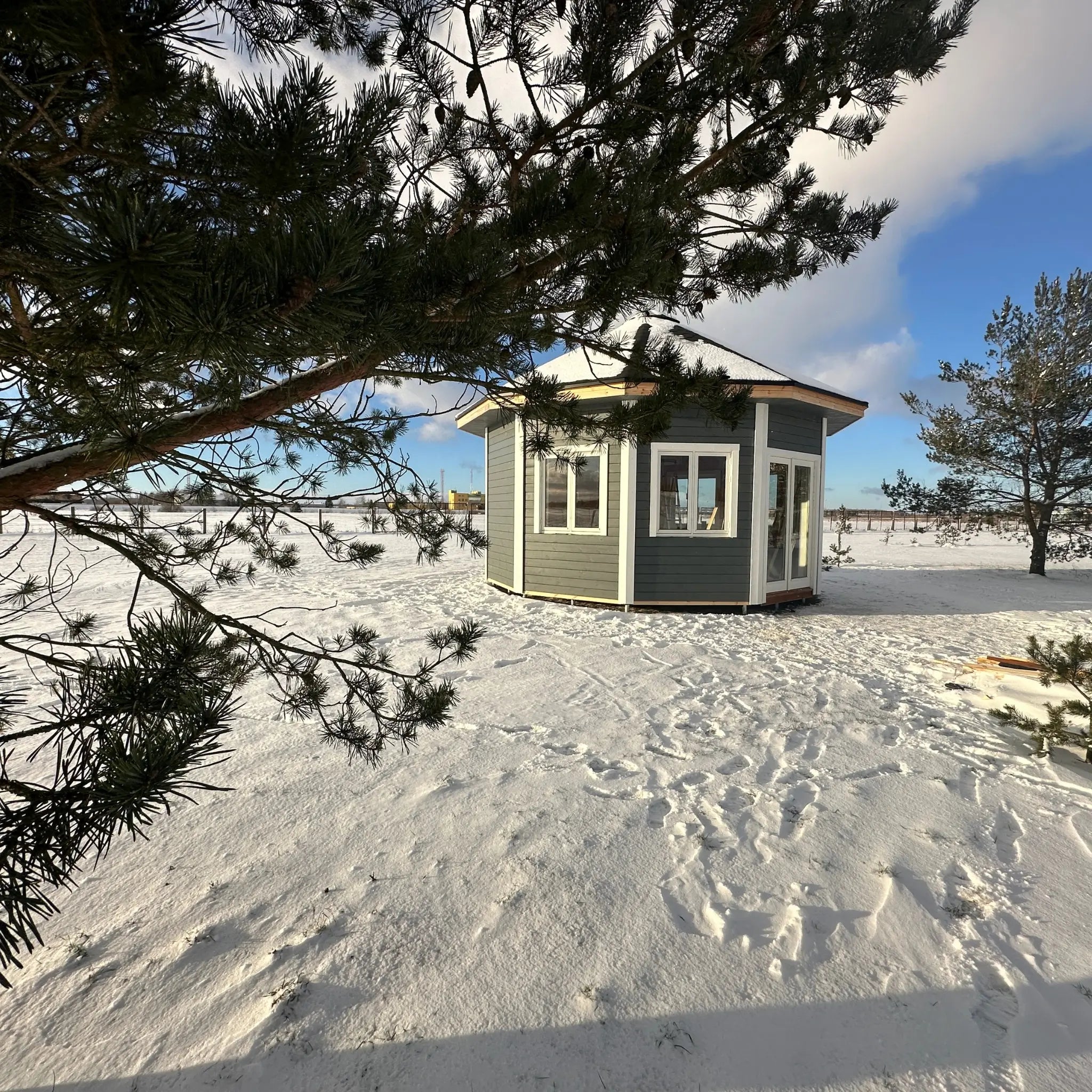 Side profile of the Altura Loft Cabin in snow highlighting window placement and proportions