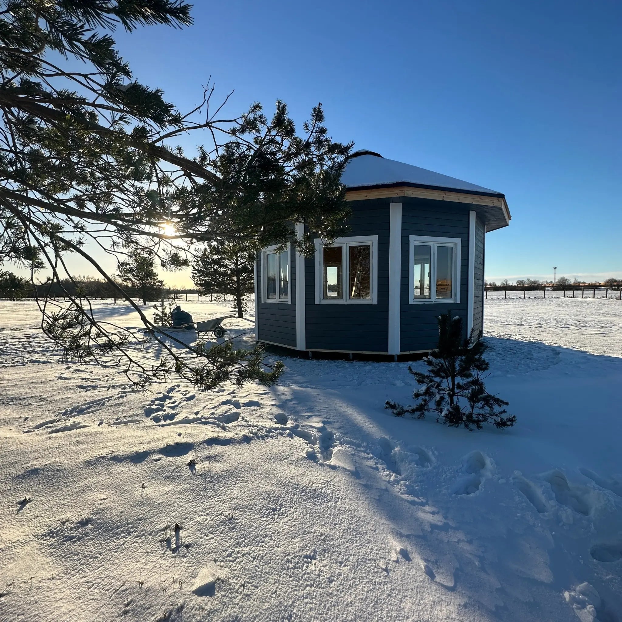 Side exterior view of the Altura Loft Cabin in snow with timber cladding and glazing