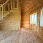 Natural timber interior finish with vaulted ceiling and structural detailing in the Altura Loft Cabin