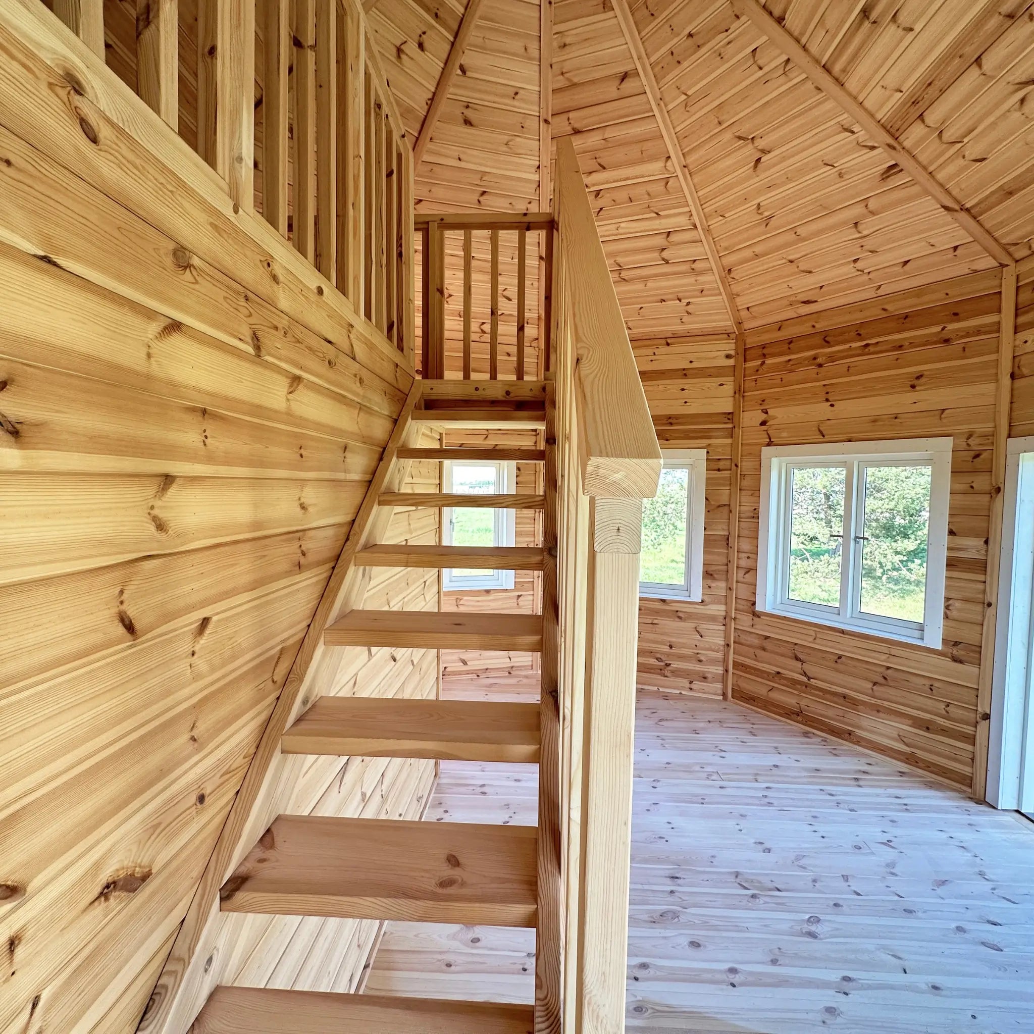 Staircase landing and loft balustrade inside the Altura Loft Cabin with exposed timber construction