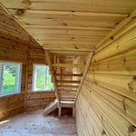 Staircase underside and support structure inside the Altura Loft Cabin with pinewood wall cladding