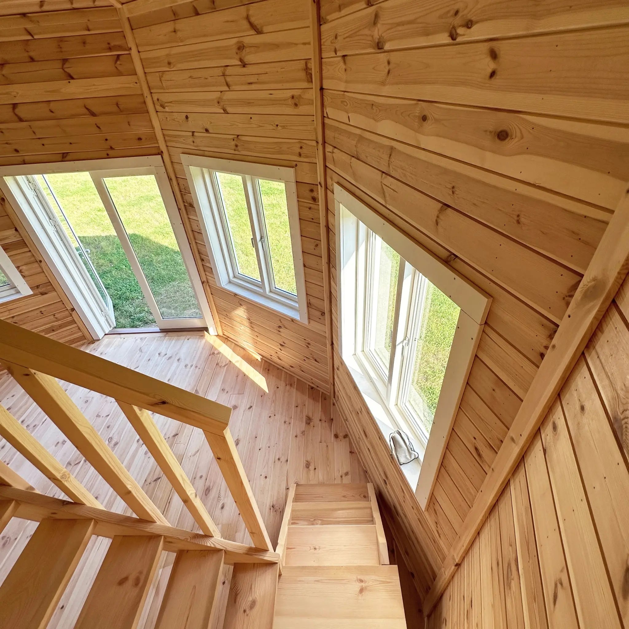 Close-up of loft ceiling and window arrangement inside the Altura Loft Cabin showing decagon roof structure