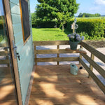 Deck corner view overlooking countryside from the Archwood shepherd’s hut