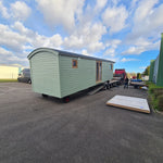 Rear exterior view of the Archwood shepherd’s hut with curved roof