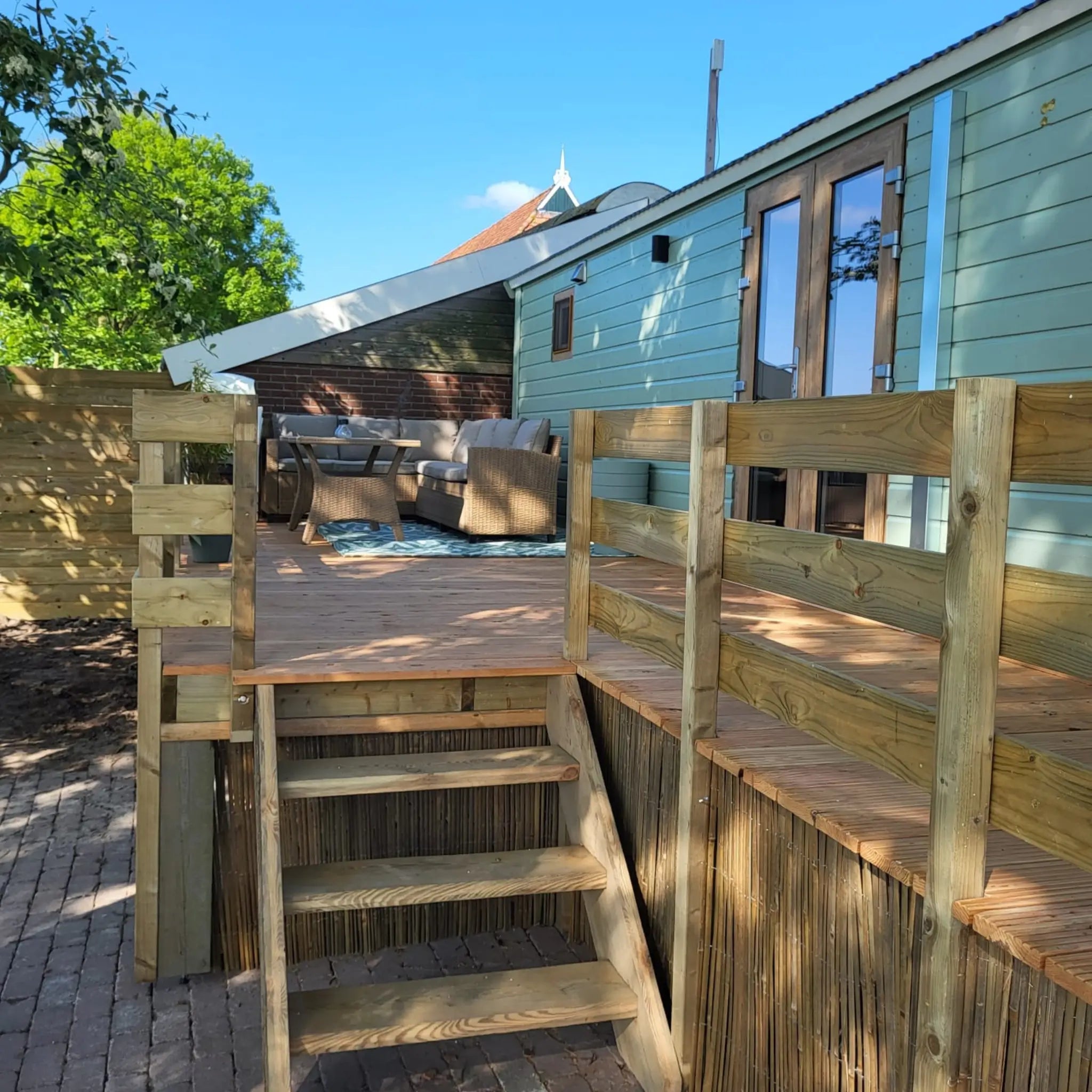 Timber deck entrance leading to the Archwood 4 person shepherd’s hut
