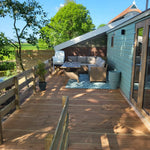 Spacious outdoor deck seating area beside the Archwood shepherd’s hut