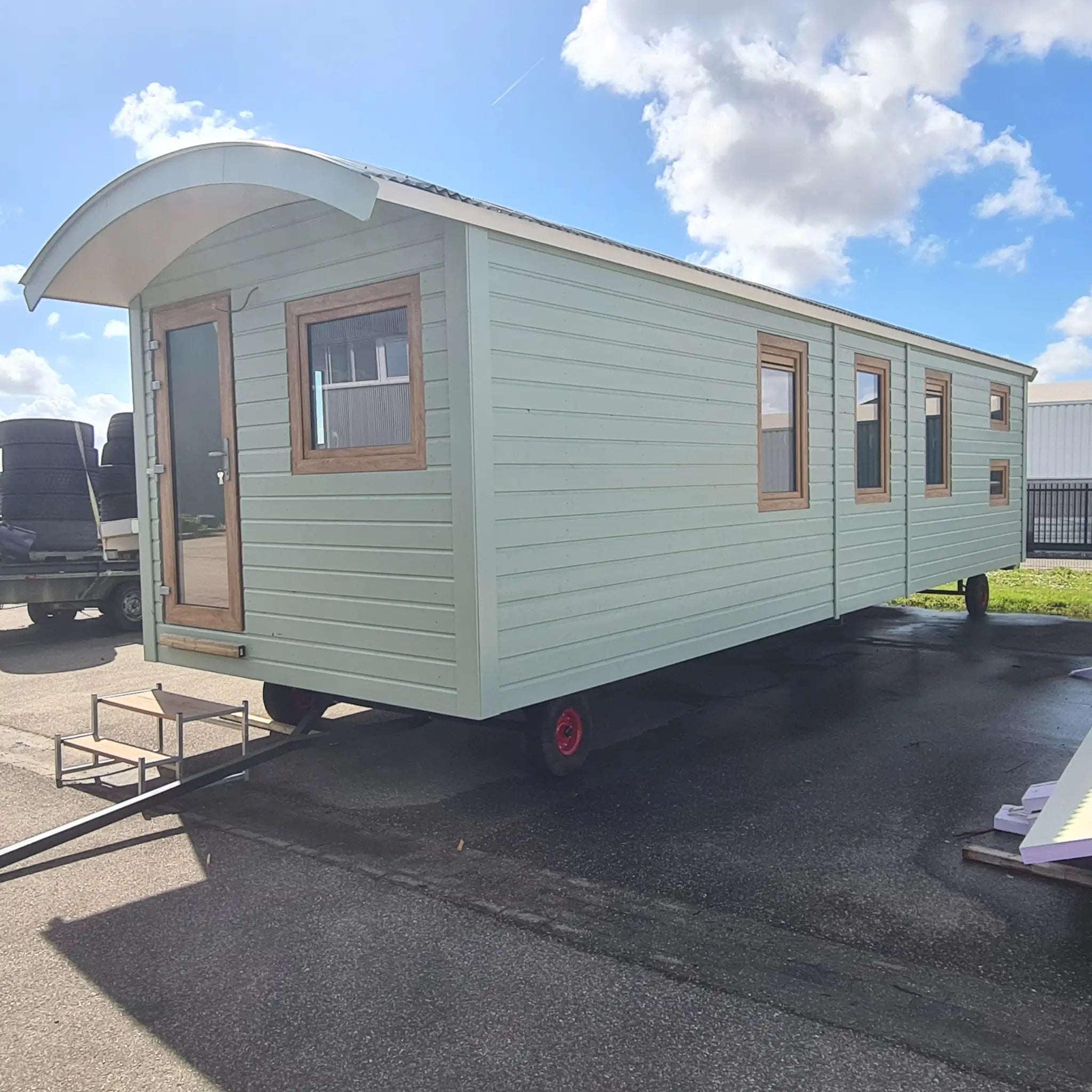 Full exterior view of Archwood shepherd’s hut on delivery trailer