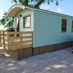 Side view of Archwood shepherd’s hut glamping accommodation with arched roof design
