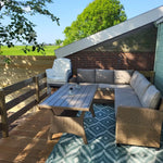 Outdoor lounge furniture on the deck of the Archwood glamping shepherd’s hut