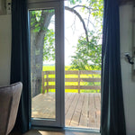Glass patio doors opening from Archwood shepherd’s hut to outdoor deck