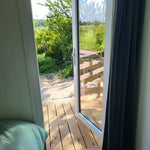 Interior window view from Archwood shepherd’s hut overlooking deck