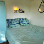 Comfortable double bed setup inside the Archwood glamping shepherd’s hut bedroom