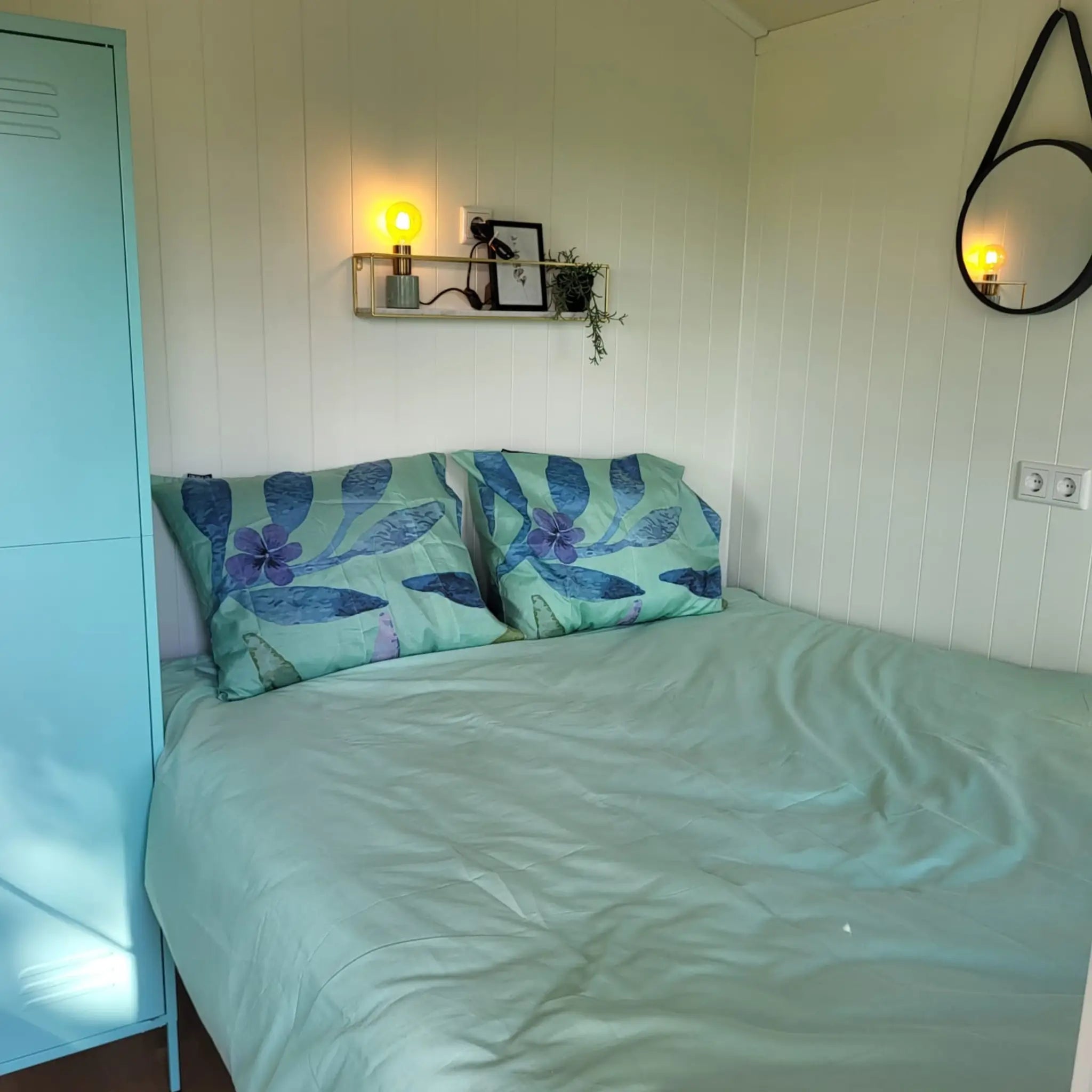 Comfortable double bed setup inside the Archwood glamping shepherd’s hut bedroom