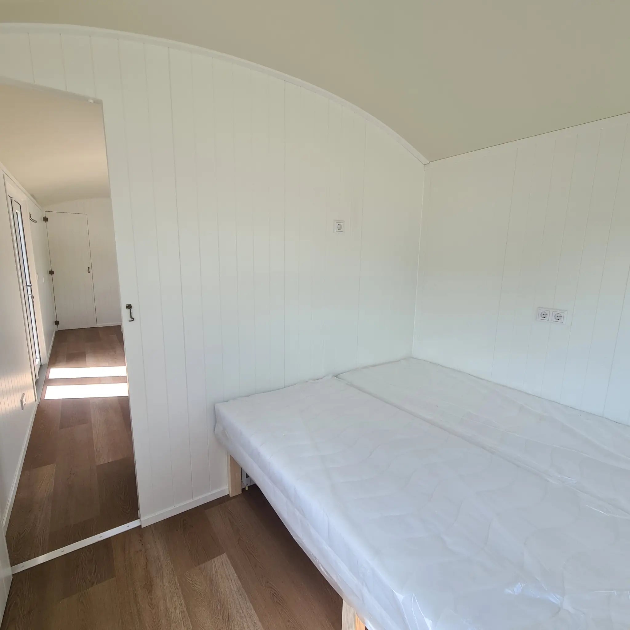 Double bed in the master bedroom inside the Archwood shepherd’s hut