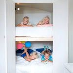 Children enjoying bunk bed sleeping area inside the Archwood shepherd’s hut