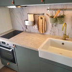 Compact kitchen with oven and storage inside the Archwood shepherd’s hut
