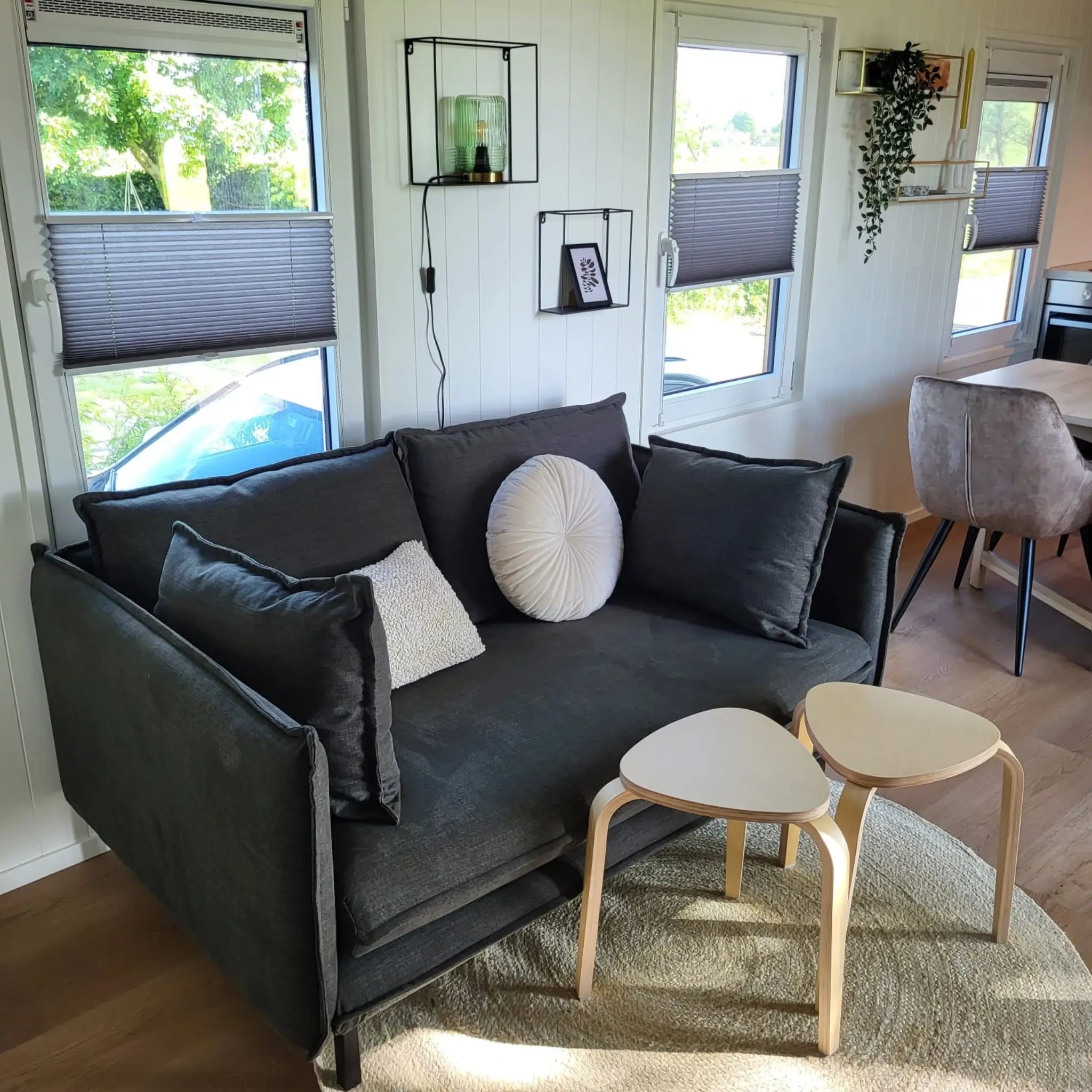 Cosy living area with sofa and coffee table inside the Archwood 4 person shepherd’s hut